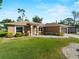 Inviting exterior view of a well-kept home, showing the manicured lawn and freshly painted facade at 3621 Jade St, North Port, FL 34288