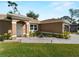 Well-maintained single-story home featuring tidy landscaping, a welcoming walkway, and large windows at 3621 Jade St, North Port, FL 34288