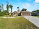 Charming single-story home features a well-manicured lawn, an oversized driveway, and a two car garage at 3621 Jade St, North Port, FL 34288