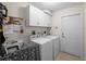 Functional laundry room with washer, dryer, and sink, providing a convenient space for laundry tasks at 3621 Jade St, North Port, FL 34288