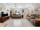 Bright living room with neutral tones, comfortable seating, and a ceiling fan at 3621 Jade St, North Port, FL 34288