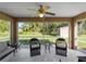 Screened patio with a ceiling fan and outdoor furniture overlooking the backyard at 3621 Jade St, North Port, FL 34288