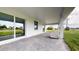 Covered back porch features brick pavers and dog house at 369 Biltmore St, Port Charlotte, FL 33953