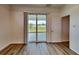 Bright room featuring wood floors, neutral walls, and sliding glass doors that provide ample natural light at 369 Biltmore St, Port Charlotte, FL 33953