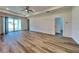 Bright living room featuring wood floors, neutral walls, and sliding glass doors to the patio at 369 Biltmore St, Port Charlotte, FL 33953