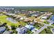 Panoramic aerial view of a vibrant residential area with a golf course, lake, and waterfront access at 3712 Carmichael Dr, Punta Gorda, FL 33950