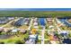 An aerial view shows the house nestled amongst waterfront homes in a golfing community with lush landscaping at 3712 Carmichael Dr, Punta Gorda, FL 33950