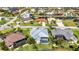 Aerial view of a house with a screened pool nestled in a waterfront community near a golf course at 3712 Carmichael Dr, Punta Gorda, FL 33950