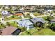 An aerial view shows a metal roofed house nestled within a picturesque golf course and waterfront community at 3712 Carmichael Dr, Punta Gorda, FL 33950
