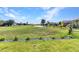 Picturesque backyard with lush lawn and views of the pond and golf course at 3712 Carmichael Dr, Punta Gorda, FL 33950