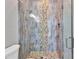 Contemporary bathroom featuring a stunning glass enclosed shower with unique stone accents and decorative tile at 3712 Carmichael Dr, Punta Gorda, FL 33950
