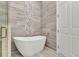 Bathroom features a modern soaking tub next to a frameless glass shower with beautiful tile work at 3712 Carmichael Dr, Punta Gorda, FL 33950