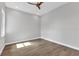 Bright bedroom featuring wood floors, ceiling fan and lots of light from the window at 3712 Carmichael Dr, Punta Gorda, FL 33950