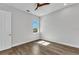 This bright bedroom has wood floors, ceiling fan and lots of natural light from the window at 3712 Carmichael Dr, Punta Gorda, FL 33950