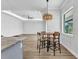 Dining area features a wood table and natural lighting from the windows at 3712 Carmichael Dr, Punta Gorda, FL 33950