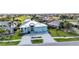 Beautiful home with a paver driveway, lush landscaping, and a view of the community golf course at 3712 Carmichael Dr, Punta Gorda, FL 33950