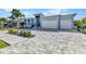 Charming home featuring a landscaped lawn and an expansive brick driveway at 3712 Carmichael Dr, Punta Gorda, FL 33950