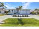 Well-maintained single-story home featuring an expansive brick driveway and neatly trimmed lawn at 3712 Carmichael Dr, Punta Gorda, FL 33950
