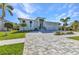 Inviting single story home with a well-kept lawn and beautiful brick driveway at 3712 Carmichael Dr, Punta Gorda, FL 33950