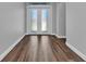 Entrance foyer with a frosted glass double door, wood look tile floor, and neutral wall paint at 3712 Carmichael Dr, Punta Gorda, FL 33950