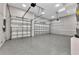 A spacious three-car garage featuring epoxy flooring and clean design offers room for all your vehicles at 3712 Carmichael Dr, Punta Gorda, FL 33950