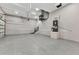 View of the impeccably clean garage featuring an epoxy floor, water heater and convenient storage at 3712 Carmichael Dr, Punta Gorda, FL 33950