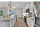 Bright kitchen includes stainless-steel appliances, a large island, and granite countertops at 3712 Carmichael Dr, Punta Gorda, FL 33950
