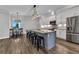 Open kitchen with large island, seating for five, stainless appliances, and modern lighting at 3712 Carmichael Dr, Punta Gorda, FL 33950