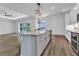 Open kitchen featuring an island with granite countertops and stainless steel appliances at 3712 Carmichael Dr, Punta Gorda, FL 33950