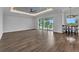 Spacious living room with modern flooring, ceiling fan, and access to the outdoor patio at 3712 Carmichael Dr, Punta Gorda, FL 33950