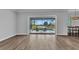 Bright living room featuring sliding doors to outdoor pool with golf course view at 3712 Carmichael Dr, Punta Gorda, FL 33950