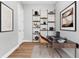 Comfortable home office with sleek desk, natural wood floors, ladder shelving, and modern decor elements at 3712 Carmichael Dr, Punta Gorda, FL 33950