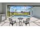 Luxury backyard featuring screened in pool, golf course views, chairs and pavers at 3712 Carmichael Dr, Punta Gorda, FL 33950