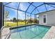 Enjoy serene backyard views of the golf course from this beautiful pool within a screened lanai at 3712 Carmichael Dr, Punta Gorda, FL 33950