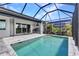 Backyard oasis featuring a screened-in pool, outdoor kitchen and patio area at 3712 Carmichael Dr, Punta Gorda, FL 33950