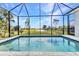 Screened-in pool offers serene views of the golf course and lush landscaping at 3712 Carmichael Dr, Punta Gorda, FL 33950