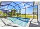 Sparkling pool in screened lanai offering views of the landscaped backyard and golf course at 3712 Carmichael Dr, Punta Gorda, FL 33950