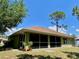 Spacious backyard featuring lush green grass and the home's screened-in porch at 3721 Adelaide Ave, North Port, FL 34288