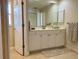 Bright bathroom with double sink vanity and white cabinets at 3721 Adelaide Ave, North Port, FL 34288