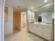 Well-lit bathroom featuring a large mirror and a shower in the background at 3721 Adelaide Ave, North Port, FL 34288