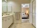 Bright bathroom with double sink vanity, white cabinets, and bedroom view at 3721 Adelaide Ave, North Port, FL 34288