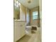 Well-lit bathroom featuring a shower-tub combination with curtain, vanity, and window at 3721 Adelaide Ave, North Port, FL 34288