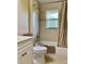 Well-lit bathroom featuring a shower-tub combination with a curtain and vanity at 3721 Adelaide Ave, North Port, FL 34288
