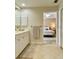 Bright bathroom with double sink vanity, white cabinets, and bedroom view at 3721 Adelaide Ave, North Port, FL 34288