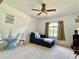 Bedroom with cozy seating, window, carpet flooring, and a ceiling fan for added comfort at 3721 Adelaide Ave, North Port, FL 34288