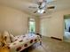 Cozy bedroom featuring a window, ceiling fan, bed with strawberry-themed linens, and a closet for storage at 3721 Adelaide Ave, North Port, FL 34288