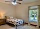 Comfortable bedroom boasting natural light, a ceiling fan, and charming strawberry-patterned bedding at 3721 Adelaide Ave, North Port, FL 34288