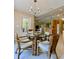 Bright eat-in kitchen featuring wicker chairs, glass top table, and access to main kitchen at 3721 Adelaide Ave, North Port, FL 34288