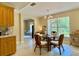 Dining room featuring a glass table, chandelier, and large windows overlooking the outdoors at 3721 Adelaide Ave, North Port, FL 34288