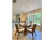 Elegant dining space with a glass table and chairs, complemented by a scenic view at 3721 Adelaide Ave, North Port, FL 34288